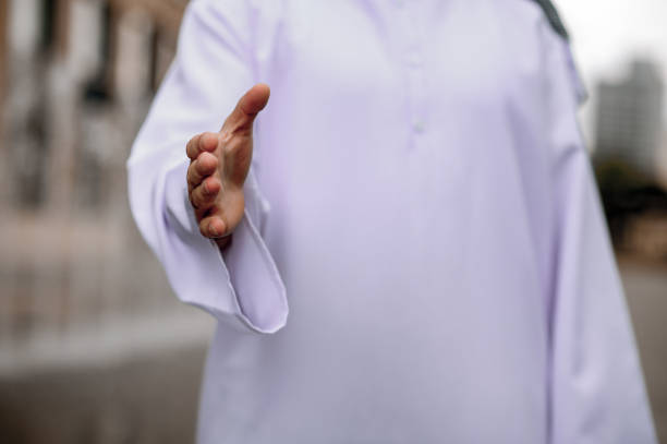 istock A man in traditional arabian strecthing his hand for a handshake 1364413736