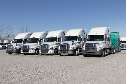 Indianapolis - Circa January 2022: Freightliner Semi Tractor Trailer Trucks Lined up for sale. Freightliner is owned by Daimler.