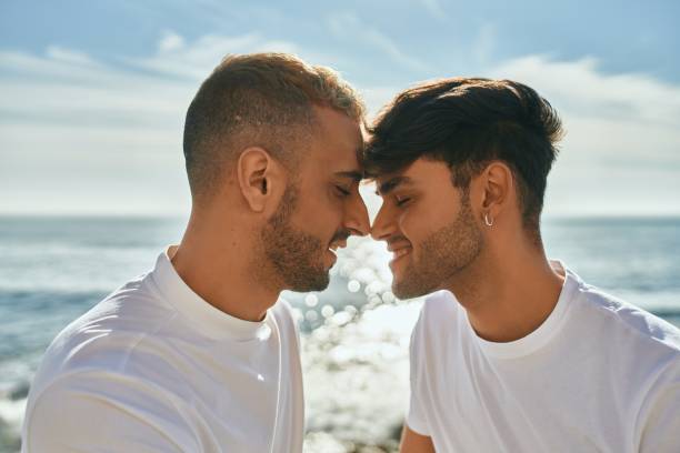 istock Romantic gay couple at the beach. 1364414086