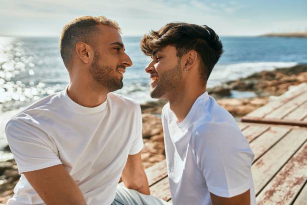 istock Romantic gay couple at the beach. 1364414087
