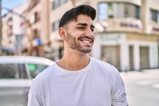 istock Handsome hispanic man smiling happy outdoors 1364415693