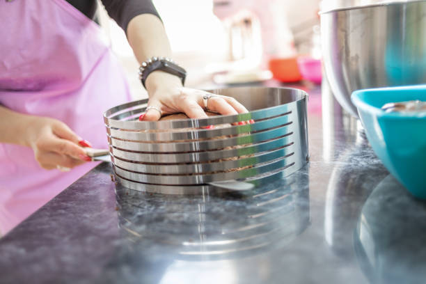 istock A young woman prepares a cake in her kitchen 1364415942