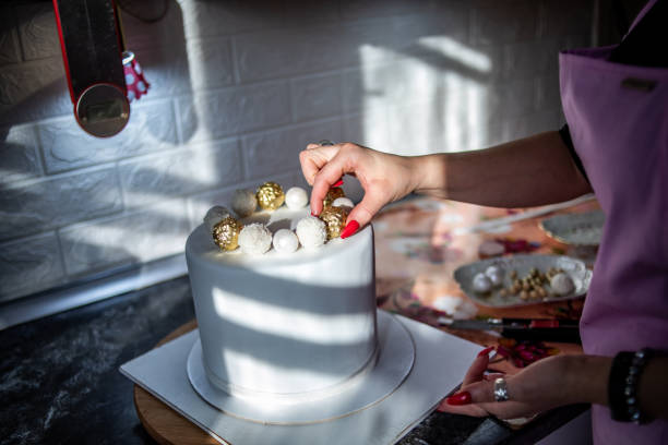 cake with candle number two and fruit on the table on the Scandinavian-style kitchen interior. minimalist and light interior. design of the photo studio. furniture made of wood.