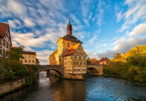 Scenic view of Old Town Hall of Bamberg, Germany under moving picturesque clouds at sunny autumn day. UNESCO World Heritage Site.