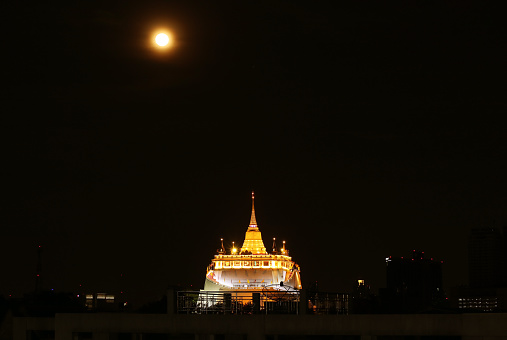 Light-up Phu Khao Thong Stupa of Wat Saket Temple on the Amazing Full Moon Night, Historic Temple in Bangkok, Thailand