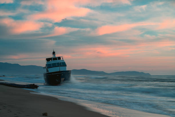 boat aground on the beach with sunset colors