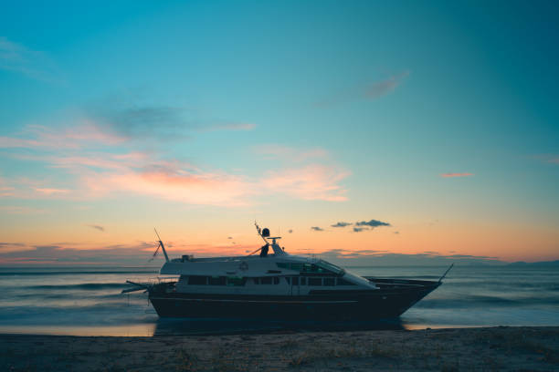 boat aground on the beach with sunset colors