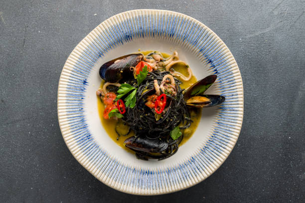 istock black spaghetti with seafood on grey concrete table top view 1364422074