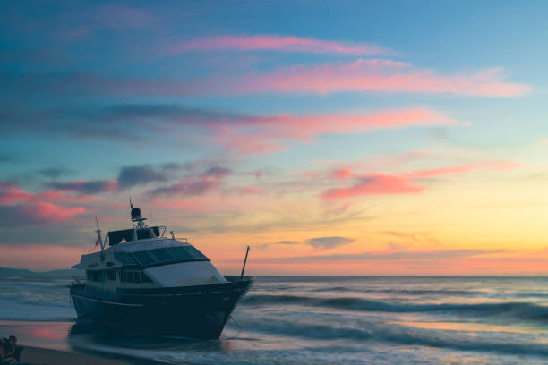 boat aground on the beach with sunset colors