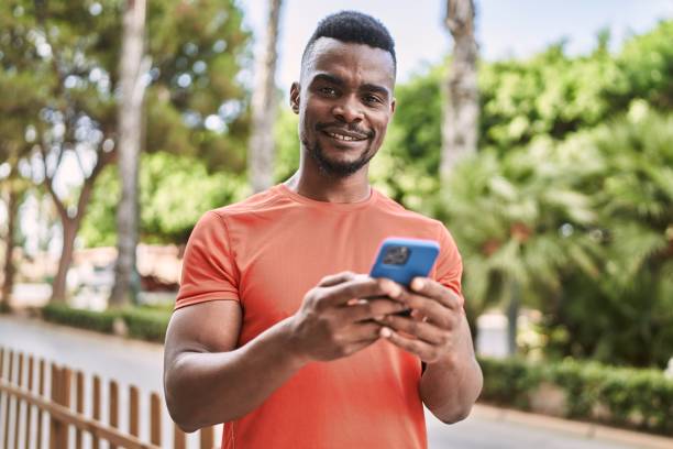 istock Young african american man smiling confident using smartphone at park 1364422411