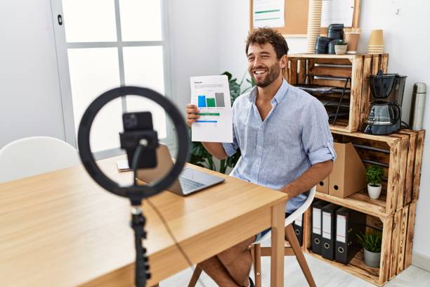 istock Young hispanic businessman having video call using smartphone at the office. 1364423895
