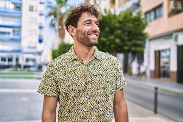 istock Young hispanic man smiling confident walking at street 1364423911