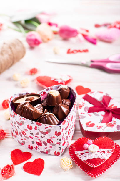 istock Chokolate box in shape of heart on white wooden table valentine background low angle view 1364424083