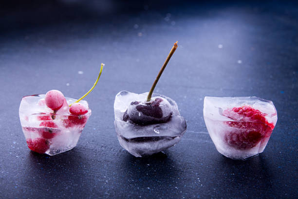 Frozen Forest Berries in Crystal Glass Held by Hand
