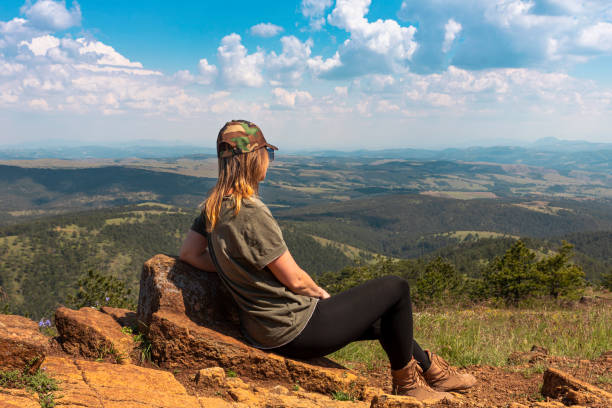 tourist girl hiker resting at the top of the mountain and enjoying amazing landscape view of mountains and beautiful sky - tourist photographing armed forces military imagens e fotografias de stock