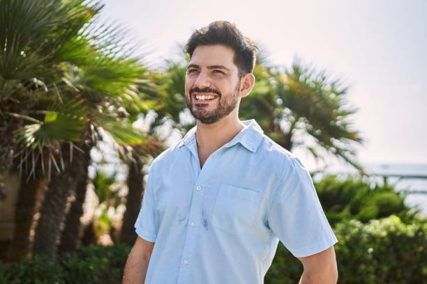 istock Young hispanic man smiling happy standing at the promenade 1364425899