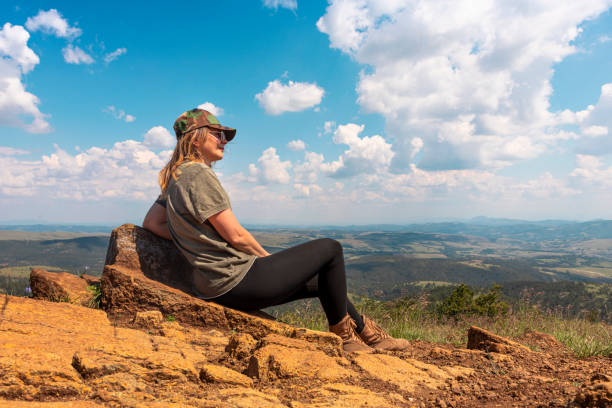 tourist girl hiker resting at the top of the mountain and enjoying amazing landscape view of mountains and beautiful sky - tourist photographing armed forces military imagens e fotografias de stock