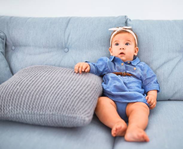 istock Adorable baby lying down on the sofa at home. Newborn relaxing and resting comfortable 1364427687