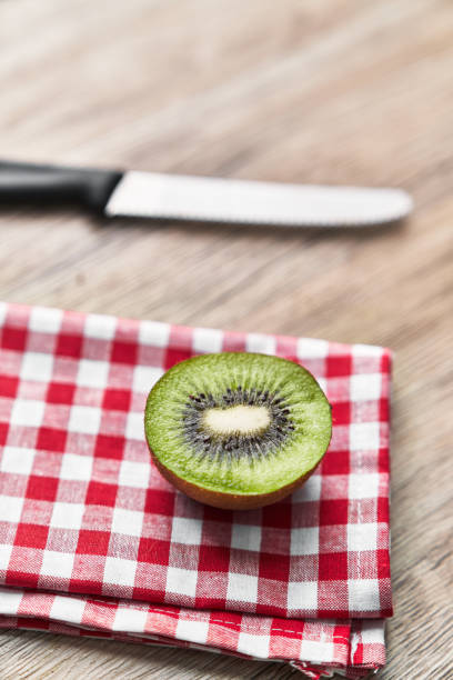 Slice of kiwi on a wooden table