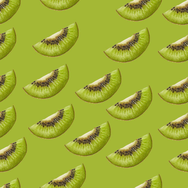 istock Slices of kiwi on a green background 1364430139
