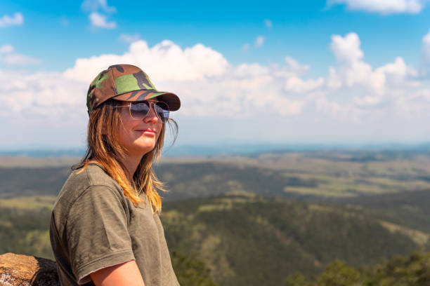 tourist girl hiker resting at the top of the mountain and enjoying amazing landscape view of mountains and beautiful sky - tourist photographing armed forces military imagens e fotografias de stock