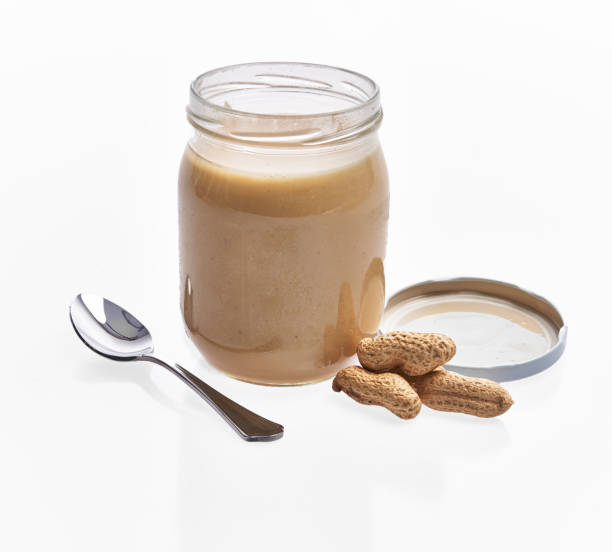 istock Bottle of peanut butter cream isolated on a white background 1364430181