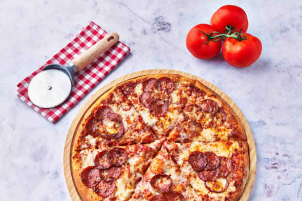 istock Delicious pepperoni italian pizza on a marble surface 1364430312