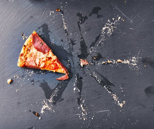 istock Slice of italian pizza on blackboard surface 1364430363