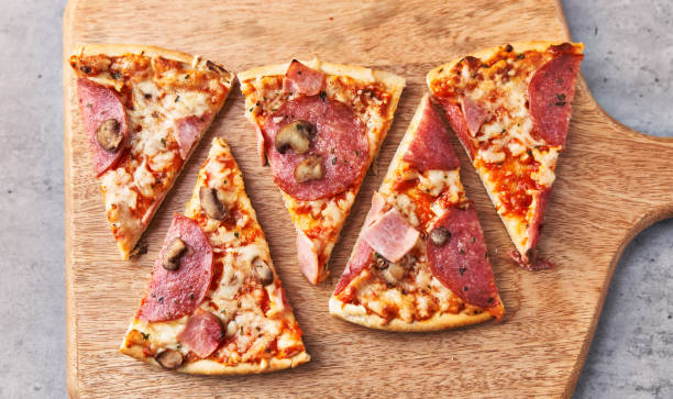 istock Slices of italian pizza on a concrete surface 1364430381
