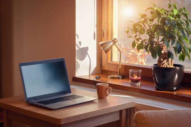 istock Home working place with laptop. Cozy home interior in the warm window light. 1364431117