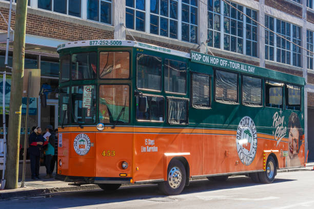 Boston Massachusetts, United States - August 4, 2021: Trolley tour bus with stop at the New England Aquarium, full of tourists. This private company trolley service combines history, fun facts, colorful anecdotes, and service to provide their guests with a memorable vacation experience.