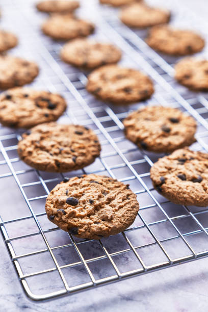 istock Chocolate cookies served on a grid rack on a marble table 1364431873