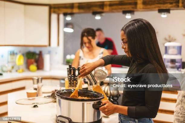 Generation Z Multiracial Group Of Friends Cooking And Eating Chili Playing Relaxing And Communicating In Modern Home Photo Series Stock Photo - Download Image Now