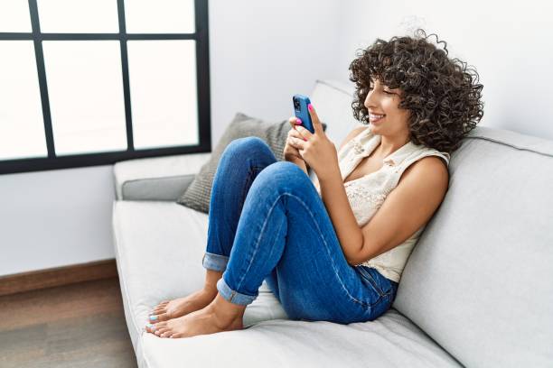 istock Young middle east woman smiling confident using smartphone at home 1364432032