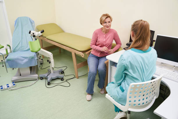 istock Cheerful patient looking at her female doctor 1364432313