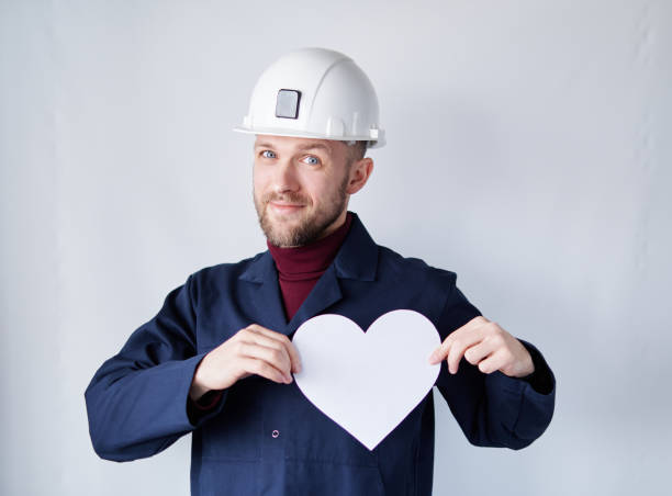 istock Contractor or engineer in hard hat with white paper heart 1364437364