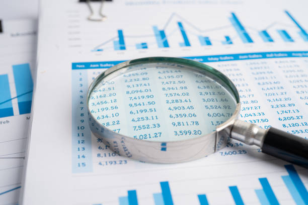 istock Magnifying glass on charts graphs paper. Financial development, Banking Account, Statistics, Investment Analytic research data economy, Stock exchange trading, Business office company meeting concept. 1364440877