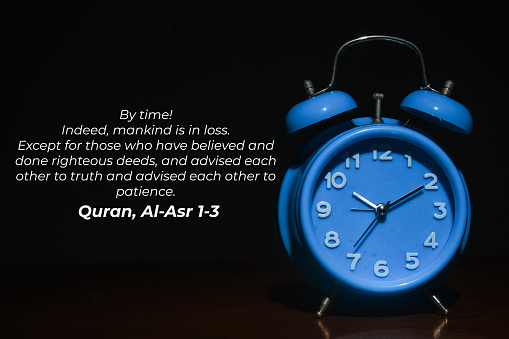 A picture of alarm clock in dark mode with Quran verse explaining about time management. Words taken from Al-Asr verse 1 until 3 in Quran