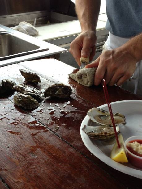 istock Shucking an oyster 1364441540