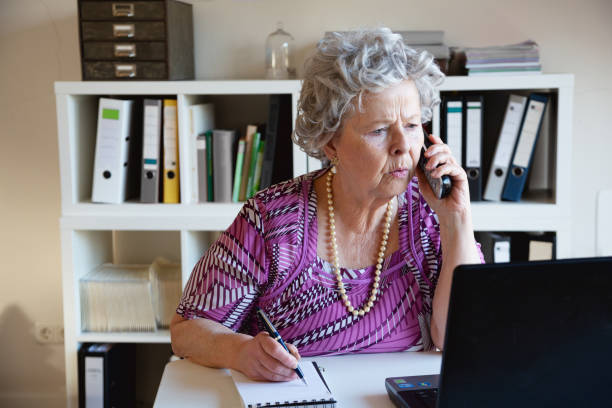 istock Senior woman working in home office 1364442463