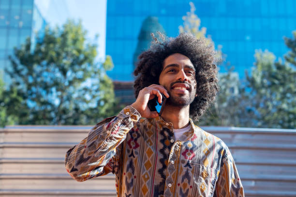 istock Afro man talking on the phone outdoors. 1364442532