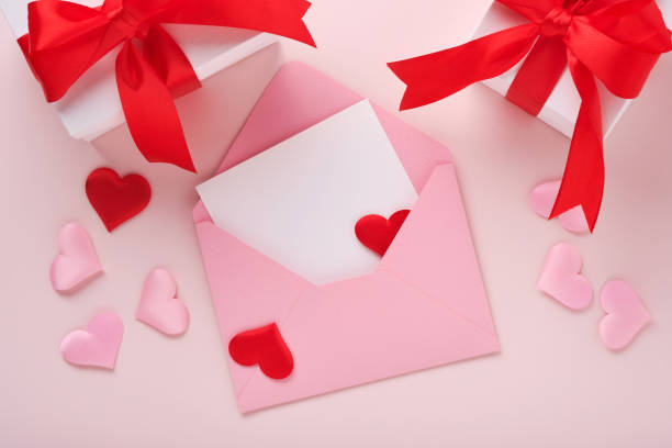 istock White gift boxes with red ribbon and small red decorative hearts on pink background. Top view with copy space. Valentines day or Wedding romantic concept. Festive composition. Mock up. 1364442545
