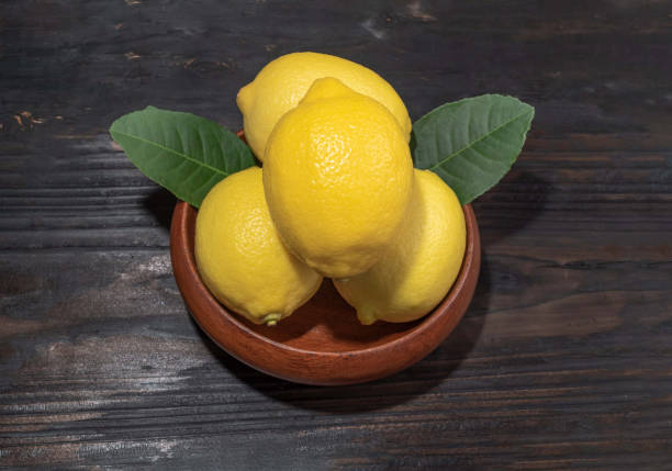 istock Pile lemon in bowl on wood background. 1364444203