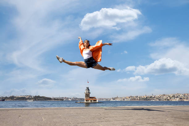 Beautiful dancer dancing front of maiden's tower view in Istanbul city Beautiful dancer dancing front of maiden's tower view in Istanbul city maidens tower turkey photos stock pictures, royalty-free photos & images