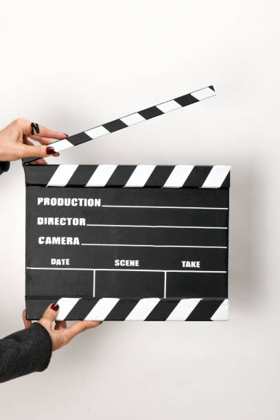 istock Woman with film clapper on white background 1364444378