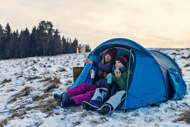 istock Kids enjoying camping in tent on the hill 1364445664