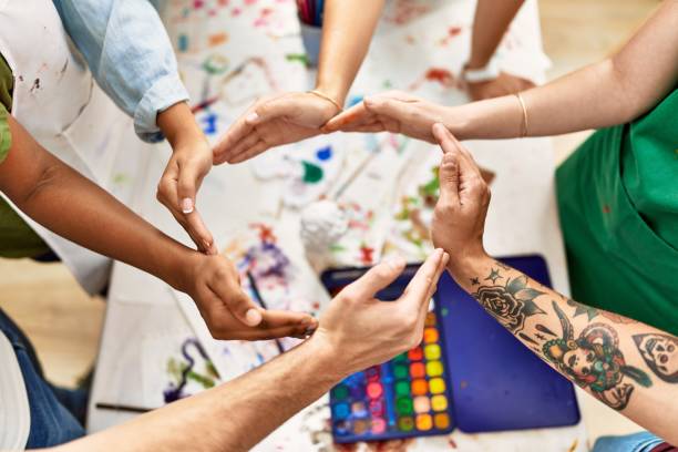 istock Group of people with hands together art studio. 1364446115