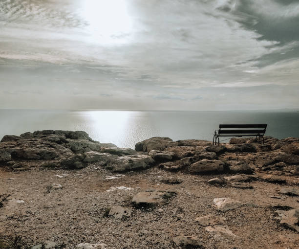 istock Summer sunny landscape. Cavo Greco, Cyprus, Mediterranean Sea coast. An empty bench on a cliff. 1364447265