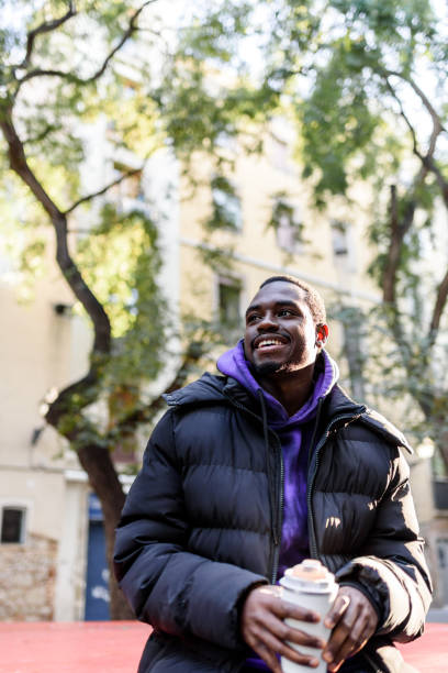 istock Optimistic black male with coffee to go 1364450475