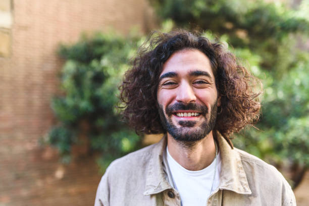 istock Happy Hispanic man on street 1364450668